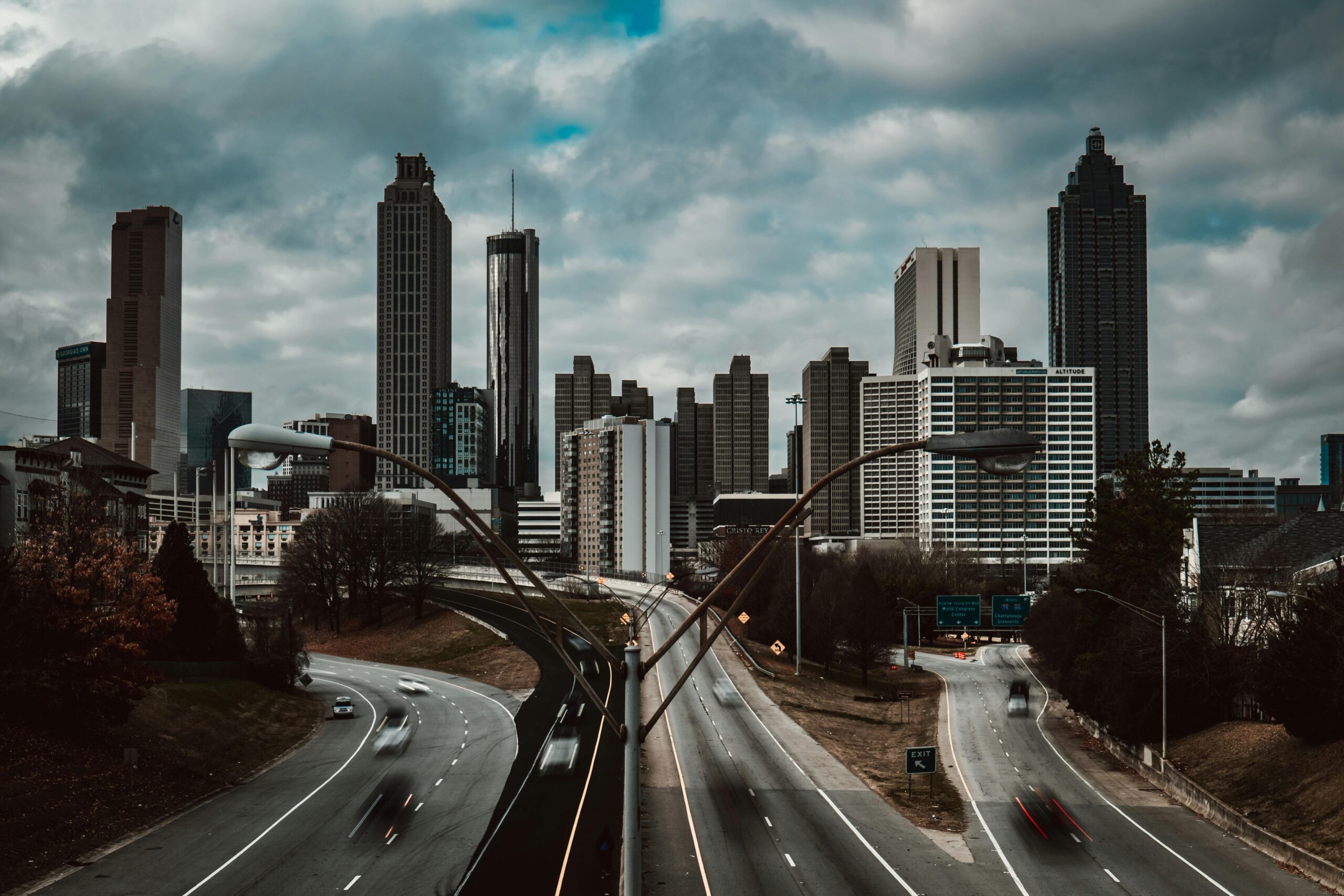 View of the Atlanta skyline on a cloudy day with highways in the foreground.